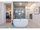 Bright bathroom boasts a freestanding tub and a glass-enclosed shower with sleek finishes at 25751 S 227Th Way, Queen Creek, AZ 85142