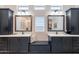 Stylish bathroom features dual sinks with dark cabinets, white countertops, and bench with storage at 25751 S 227Th Way, Queen Creek, AZ 85142