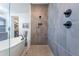 Modern tiled shower with glass enclosure, rainfall showerhead, and adjacent soaking tub at 25751 S 227Th Way, Queen Creek, AZ 85142