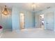 Airy bedroom with multiple doors, modern light fixture, and ample space at 25751 S 227Th Way, Queen Creek, AZ 85142