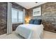 A brick accent wall, a window with plantation shutters, and a well-decorated design are features of this bedroom at 25751 S 227Th Way, Queen Creek, AZ 85142