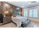 Stylish bedroom featuring a wood accent wall, bench, and neutral decor at 25751 S 227Th Way, Queen Creek, AZ 85142