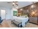 Relaxing bedroom boasting a textured accent wall, bench, and ample natural light at 25751 S 227Th Way, Queen Creek, AZ 85142