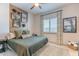 Stylish bedroom with rustic accent wall, plush bedding, and natural light creates a cozy retreat at 25751 S 227Th Way, Queen Creek, AZ 85142