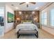 Comfortable bedroom featuring a textured accent wall, bench seating, and abundant natural light at 25751 S 227Th Way, Queen Creek, AZ 85142