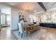Open dining area with a rustic table, stylish chairs, and access to the modern kitchen at 25751 S 227Th Way, Queen Creek, AZ 85142