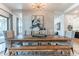 Elegant dining room with a long wooden table, upholstered chairs, and stylish lighting at 25751 S 227Th Way, Queen Creek, AZ 85142