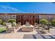 Outdoor fire pit with seating, a decorative screen, and brick pavers, ideal for cozy evenings outside at 25751 S 227Th Way, Queen Creek, AZ 85142