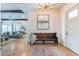Inviting foyer with hardwood floors, bench seating, artwork, and open views to the living and dining areas at 25751 S 227Th Way, Queen Creek, AZ 85142