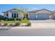Attractive single-Gathering home featuring a well-manicured lawn, a two-car garage, and a welcoming entrance at 25751 S 227Th Way, Queen Creek, AZ 85142