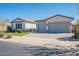 Charming single-story home with a two-car garage, beautiful landscaping, and a well-maintained front yard at 25751 S 227Th Way, Queen Creek, AZ 85142