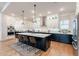 Modern kitchen featuring a large island, stainless steel appliances, pendant lighting and plenty of storage space at 25751 S 227Th Way, Queen Creek, AZ 85142
