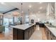 Open-concept kitchen showcasing a large island connecting it to a nearby dining area, all illuminated by recessed lighting at 25751 S 227Th Way, Queen Creek, AZ 85142