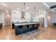 Modern kitchen featuring a large island, stainless steel appliances, pendant lighting and plenty of storage space at 25751 S 227Th Way, Queen Creek, AZ 85142