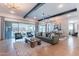 Open-concept living room featuring a comfortable sofa, large windows, and stylish décor at 25751 S 227Th Way, Queen Creek, AZ 85142