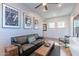 A spacious living room featuring a ceiling fan, stylish decor, and natural light at 25751 S 227Th Way, Queen Creek, AZ 85142