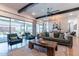 Elegant living room featuring exposed beams, ample seating, and sliding glass doors at 25751 S 227Th Way, Queen Creek, AZ 85142