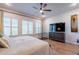 Inviting main bedroom features plantation shutters, wood floors, and a convenient dog crate at 25751 S 227Th Way, Queen Creek, AZ 85142