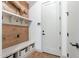 Charming mudroom with built-in bench, coat hooks, and wood accent wall; perfect for keeping organized at 25751 S 227Th Way, Queen Creek, AZ 85142