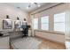 Bright office with desk, chair, natural light, and white plank accent wall creates a productive workspace at 25751 S 227Th Way, Queen Creek, AZ 85142