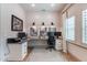 Bright office with desk, chair, natural light, and white plank accent wall creates a productive workspace at 25751 S 227Th Way, Queen Creek, AZ 85142
