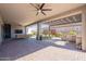 Expansive covered patio with multiple seating areas, ceiling fans, outdoor kitchen and brick pavers, perfect for entertaining at 25751 S 227Th Way, Queen Creek, AZ 85142