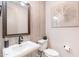 Elegant powder room features a stylish vanity, modern fixtures, and decorative wall accents for guests at 25751 S 227Th Way, Queen Creek, AZ 85142