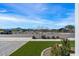 Scenic street view showcasing lush landscaping, a serene lake, and a majestic mountain backdrop on a bright, sunny day at 25751 S 227Th Way, Queen Creek, AZ 85142