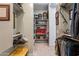 Spacious walk-in closet with built-in shelving, hanging rods, and carpeted floors at 25751 S 227Th Way, Queen Creek, AZ 85142