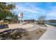 Community gathering space featuring a decorative water tower, seating areas, and lush landscaping next to a tranquil lake at 25751 S 227Th Way, Queen Creek, AZ 85142