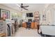 Inviting home office with wood desk, bookshelves, and neutral walls under a ceiling fan with a light at 26450 S Shumaker Dr, Sun Lakes, AZ 85248