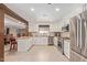 Modern kitchen with stainless steel appliances, white cabinets, and a breakfast bar that seats two at 26450 S Shumaker Dr, Sun Lakes, AZ 85248