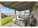 Inviting covered patio overlooking a lush backyard and sparkling pool at 2906 E Nora St, Mesa, AZ 85213