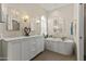 Elegant bathroom with a soaking tub, chandelier, and double vanity at 2906 E Nora St, Mesa, AZ 85213