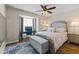 Cozy bedroom with a large rug, a window desk, and neutral decor at 2906 E Nora St, Mesa, AZ 85213