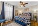 Cozy bedroom with blue accents, ceiling fan, and natural light at 2906 E Nora St, Mesa, AZ 85213