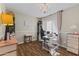 Bright bedroom with a chandelier, laminate floors, and a large window at 2906 E Nora St, Mesa, AZ 85213