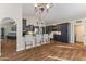 Open kitchen with a breakfast bar, dark cabinets, granite countertops, and a chandelier at 2906 E Nora St, Mesa, AZ 85213