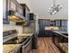 The elegant kitchen features dark cabinets, granite countertops, and stainless steel appliances at 2906 E Nora St, Mesa, AZ 85213