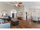 Spacious living room with hardwood floors, archways, and a modern ceiling fan at 2906 E Nora St, Mesa, AZ 85213