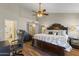 Luxurious main bedroom features a ceiling fan, vaulted ceiling, and ensuite bathroom at 2906 E Nora St, Mesa, AZ 85213