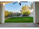 Covered patio featuring a ceiling fan with a view of the manicured backyard at 3019 E Redfield Rd, Phoenix, AZ 85032