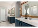 Bathroom boasts double sinks, wooden-framed mirrors, white countertops, and marble tile floor at 3019 E Redfield Rd, Phoenix, AZ 85032