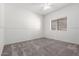 Bedroom with carpet floors, white walls, a window and a ceiling fan at 3019 E Redfield Rd, Phoenix, AZ 85032