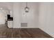 Open dining space featuring wood-look floors and a modern pendant light fixture at 3019 E Redfield Rd, Phoenix, AZ 85032