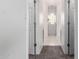 Hallway leading to a bathroom, featuring modern gray carpet and white interior doors at 3019 E Redfield Rd, Phoenix, AZ 85032