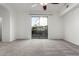 Spacious bedroom featuring soft carpet and a slider with backyard views at 3019 E Redfield Rd, Phoenix, AZ 85032