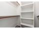 Organized walk-in closet with shelves and hanging rods for optimal storage space at 3019 E Redfield Rd, Phoenix, AZ 85032