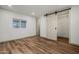 Bright bedroom with wood-look floors, modern sliding closet doors, and a window at 3104 E Broadway Rd -- # 287, Mesa, AZ 85204