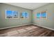Bedroom features wood-look floors, green walls, and multiple bright windows at 3104 E Broadway Rd -- # 287, Mesa, AZ 85204